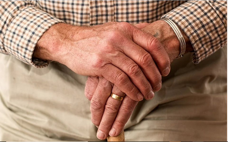 a senior man wearing a ring
